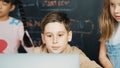 Boy using laptop programing engineering code and writing program. Erudition. Royalty Free Stock Photo