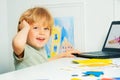 Boy using laptop for remote education videos over internet Royalty Free Stock Photo