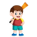 The boy using the red clotheis holding the broom for cleaning the trash