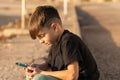 Boy using smartphone on beach Royalty Free Stock Photo