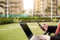 Boy is using smartphone in hand with laptop Royalty Free Stock Photo