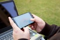 Boy is using smartphone with laptop Royalty Free Stock Photo