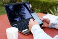 Boy is using smartphone with laptop and cup Royalty Free Stock Photo