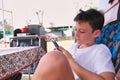 Boy using smartphone outside camper