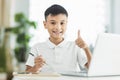 Boy using tablet and laptop.Study online class.Showing thumb up Royalty Free Stock Photo