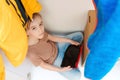 Boy using tablet pc at home. Boy hiding in wardrobe. Kid playing video games, sitting inside modern wardrobe Royalty Free Stock Photo