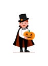 A boy in a vampire costume is standing and holding a pumpkin in his hands. Royalty Free Stock Photo