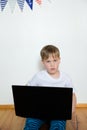 Boy video conferencing with tutor on laptop at home. Distance education concept Royalty Free Stock Photo