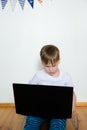 Boy video conferencing with tutor on laptop at home. Distance education concept Royalty Free Stock Photo