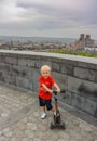 A boy with a view of Yerevan from Tsitsernakaberd-the Armenian genocide memorial complex is the official monument to the Royalty Free Stock Photo