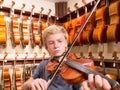 Boy Violinist Playing A Violin In A Music Store Royalty Free Stock Photo