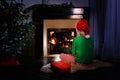 Boy wait with present for Christmas near fireplace Royalty Free Stock Photo