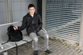 Boy waiting at school bus stop Royalty Free Stock Photo