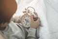 Boy wake up on bed and looking at late alarm clock in the morning