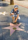 Boy at the  Walk of Fame poses at the star for The simpsons Royalty Free Stock Photo