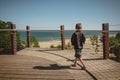 Boy walking along Indiana Dunes State Park Bird Observatory, looking out at Lake Michigan Royalty Free Stock Photo