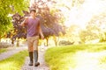 Boy Walking Along Path Carrying Fishing Net And Jar Royalty Free Stock Photo