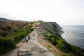 Boy walking on a cliff near sea view. Cape Emine, Black sea coast, Bulgaria