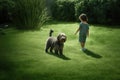 boy walking with a dog on a green summer grassy lawn