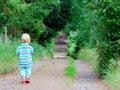 Boy walking down a walkway