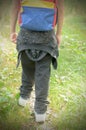 A boy walking in a hike in sneakers and a backpack behind his shoulders. Royalty Free Stock Photo