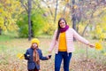 Boy walking with his mother in autumn park Royalty Free Stock Photo