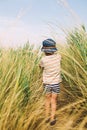 Boy walking hrough grass