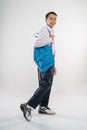 a boy walking in junior high school uniform smiling with carrying a backpack Royalty Free Stock Photo