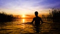 Boy walking in the lake Sunset Royalty Free Stock Photo