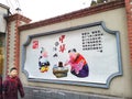 Boy walking past propaganda poster on Shanghai street