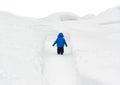 Boy Walking Through Snowy Path