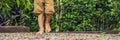 Boy Walking On A Textured Cobble Pavement, Reflexology. Pebble stones on the pavement for foot reflexology BANNER long format Royalty Free Stock Photo