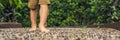 Boy Walking On A Textured Cobble Pavement, Reflexology. Pebble stones on the pavement for foot reflexology BANNER long format Royalty Free Stock Photo