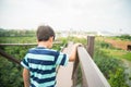 Boy walking on the wood bridge city park Royalty Free Stock Photo