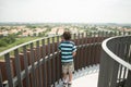 Boy walking on the wood bridge city park Royalty Free Stock Photo