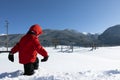 A boy walks through deep friable snow in the winter