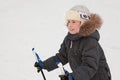 Boy in warm sport dress skiing at forest