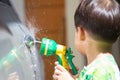Boy washed car by water spray Royalty Free Stock Photo