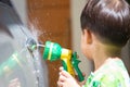 Boy washed car by water spray