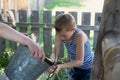 Boy washes well water. Royalty Free Stock Photo