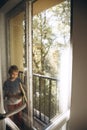 A boy washes windows at home using a cordless window cleaner. Selective focus