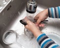 Boy washing dishes in the kitchen Royalty Free Stock Photo