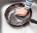 Boy washing dishes in the kitchen Royalty Free Stock Photo