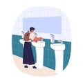 Boy washing hand in public restroom, school WC. Schoolchild, pupil standing at sink, washstand in toilet, closet Royalty Free Stock Photo