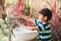 Boy washing hand at toilet park outdoor Royalty Free Stock Photo