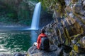 Boy watching the Bassin La Paix waterfall in Reunion Island
