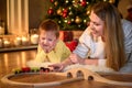 Boy is watching his mom playing with toy train Royalty Free Stock Photo