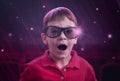 Boy watching movie in cinema with 3d glasses. Delighted face expression Royalty Free Stock Photo