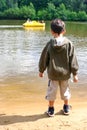 Boy watching pedalo in lake Royalty Free Stock Photo