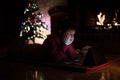 Boy watching tablet beside Christmas tree a Royalty Free Stock Photo